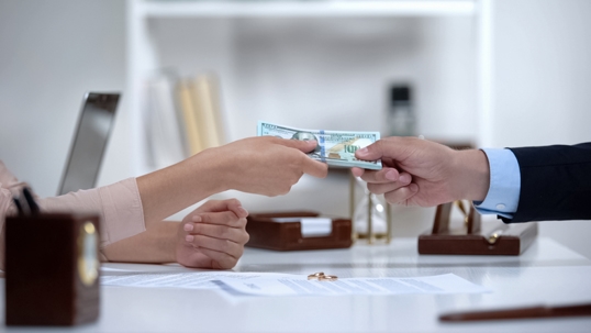 money exchanging hands in a lawyer's office