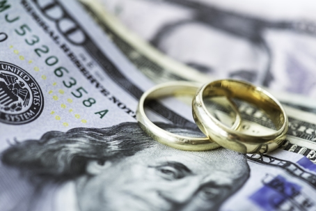 wedding rings on top of cash