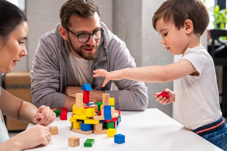 Parents with Child Playing with Blocks