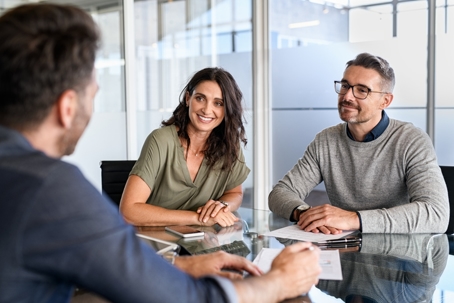 couple discussing documents with a lawyer