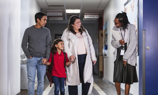 parents and child speaking with teacher