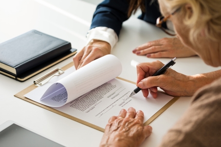 person signing document in lawyer's office