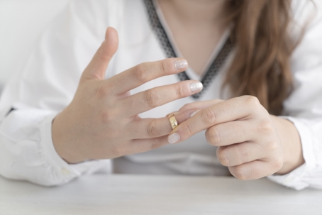 woman removing wedding ring