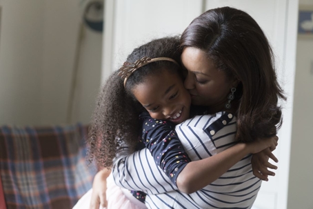 Mother embracing her daughter in a hug